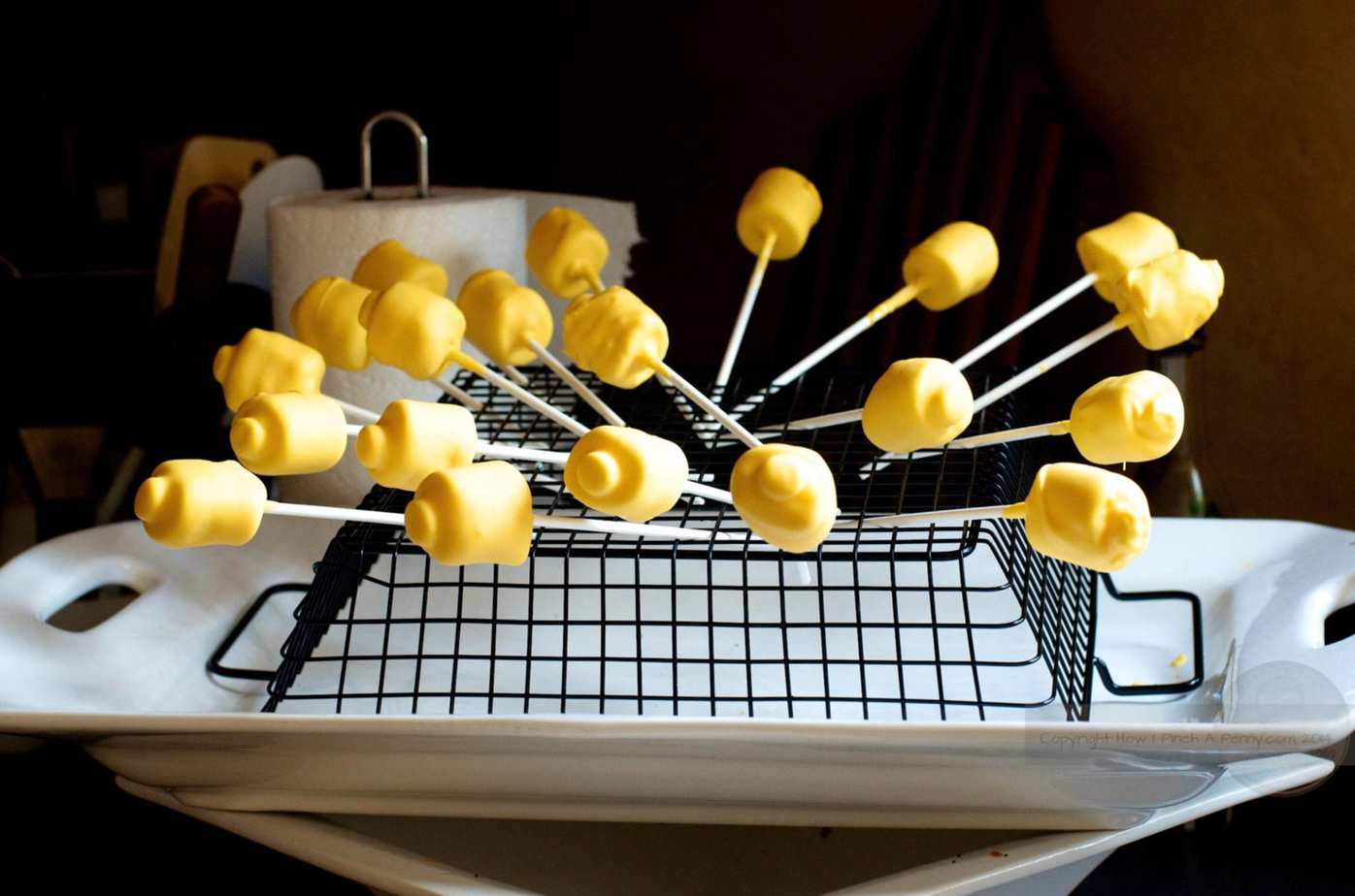 Lego Head Marshmallow Pops drying on a rack