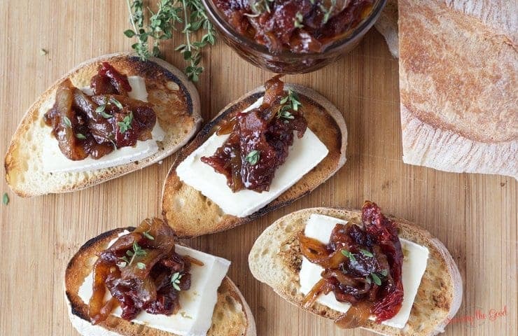 Bacon onion tomato jam is the perfect addition to any charcuterie board. This recipe is the perfect combination of sweet and savory. A hint of thyme balances out the trio of flavors. A staple for your refrigerator or a lovely gift to give as a hostess gift or to friends and family at the holidays.