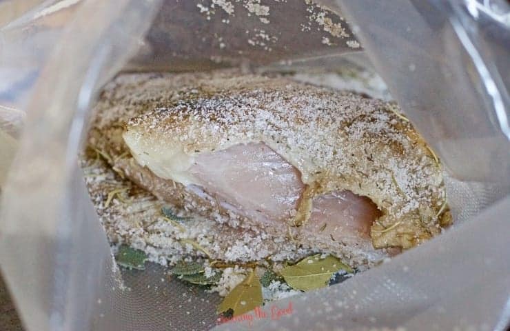 Sous Vide Turkey Breast in the cooking bag with seasonings and oil.