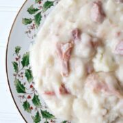 A plate of mashed potatoes with ham.