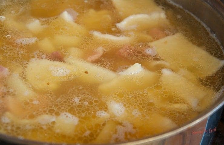 ham pot pie squares and broth simmering in a pot