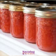 A row of freezer jars filled with strawberry jam.