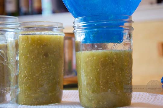 salsa verde in ball mason jars blue funnel