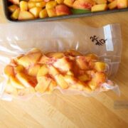 Learn how to freeze peaches by placing them in plastic bags on a table for future use.