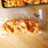 Learn how to freeze peaches by placing them in plastic bags on a table for future use.
