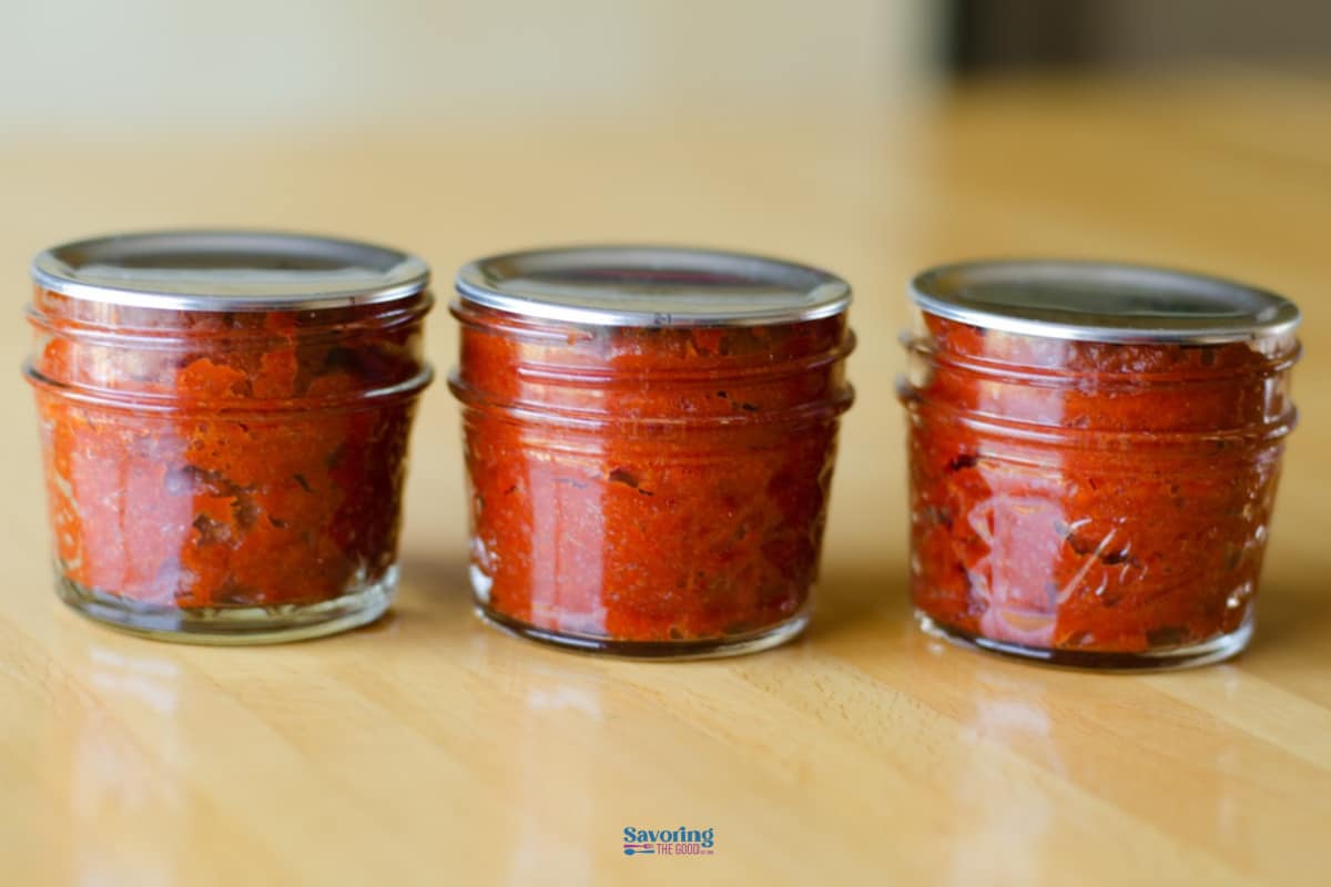When your garden is overflowing with ripe tomatoes, it is the perfect time to make homemade tomato paste. This tomato paste recipe has only three ingredients and there are two options for storing the tomato paste. Once you know how to make homemade tomato paste, store bought will no longer be an option for you. #tomato #tomatopaste #summertomatoes #backyardgarden #containergardening Home Made Tomato Paste in mason jar