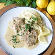 A plate with lemon piccata pasta on it.