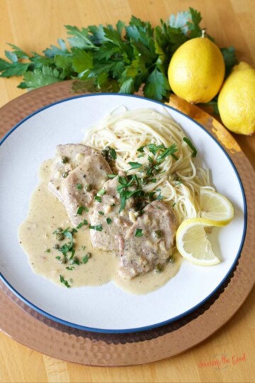 A plate with lemon piccata pasta on it.
