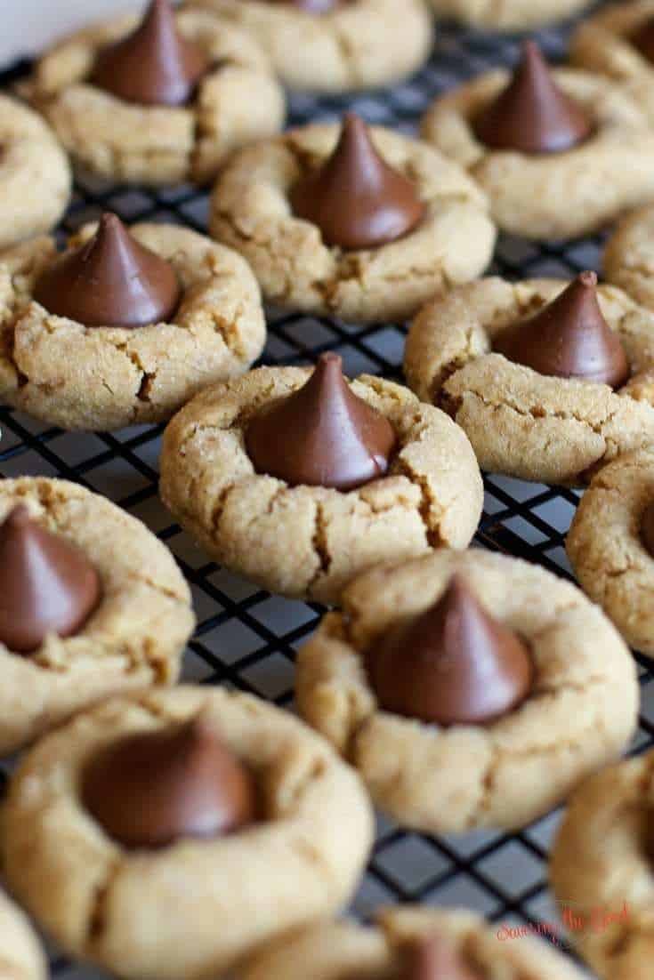 full recipe of Peanut Butter Kiss Cookies cooling on a cooling rack