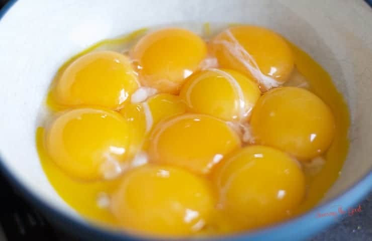 one dozen egg yolks in a bowl