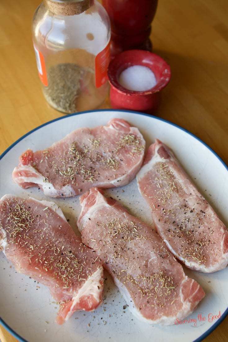 raw pork chops on a plate