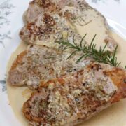 Sous vide boneless pork chops with rosemary garnish.