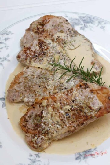 Sous vide boneless pork chops with rosemary garnish.