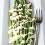 Sous Vide hollandaise on asparagus on a white plate