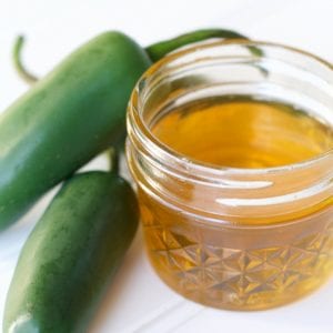 Jalapeno honey is the perfect balance of heat and sweet. Easily infuse jalapeno honey with the help of sous vide in hours, instead of weeks. Start with this hot honey infusion recipe and you will be inspired to create other infused honeys. Try this infused honey in cocktails, poured over cheese or drizzled on pizza. #infusedhoney #sousvide #sousviderecipe #hothoney