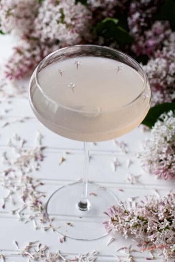 lilac bee's knees cocktail in glass