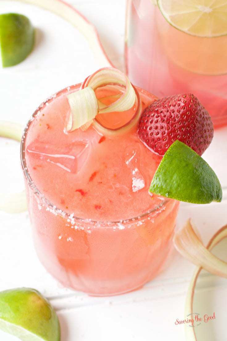 Strawberry Rhubarb Margarita in a salt rimmed glass with garnish