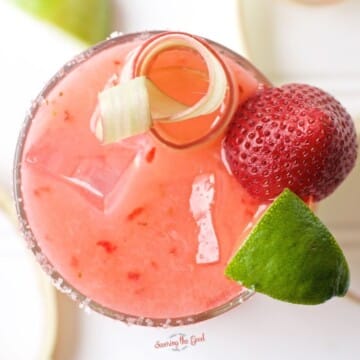 A Strawberry Rhubarb Margarita with lime and strawberries.