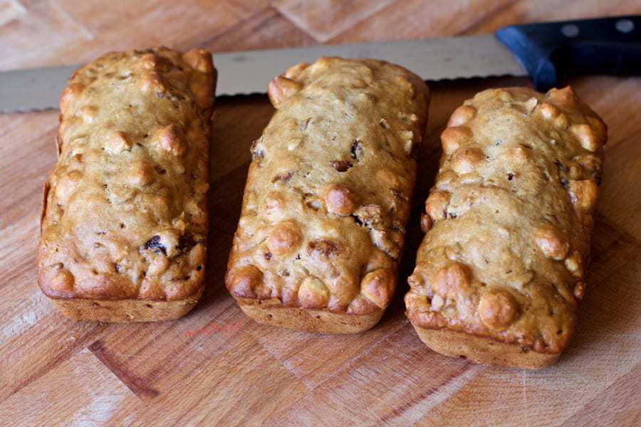full almondina loaf cakes cooking on a bamboo cutting board