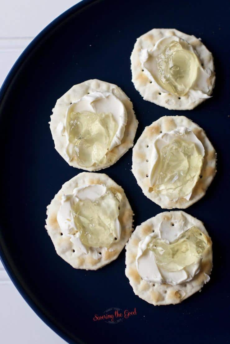Corn Cob Jelly 5 crackers with cream cheese on a matte blue plate