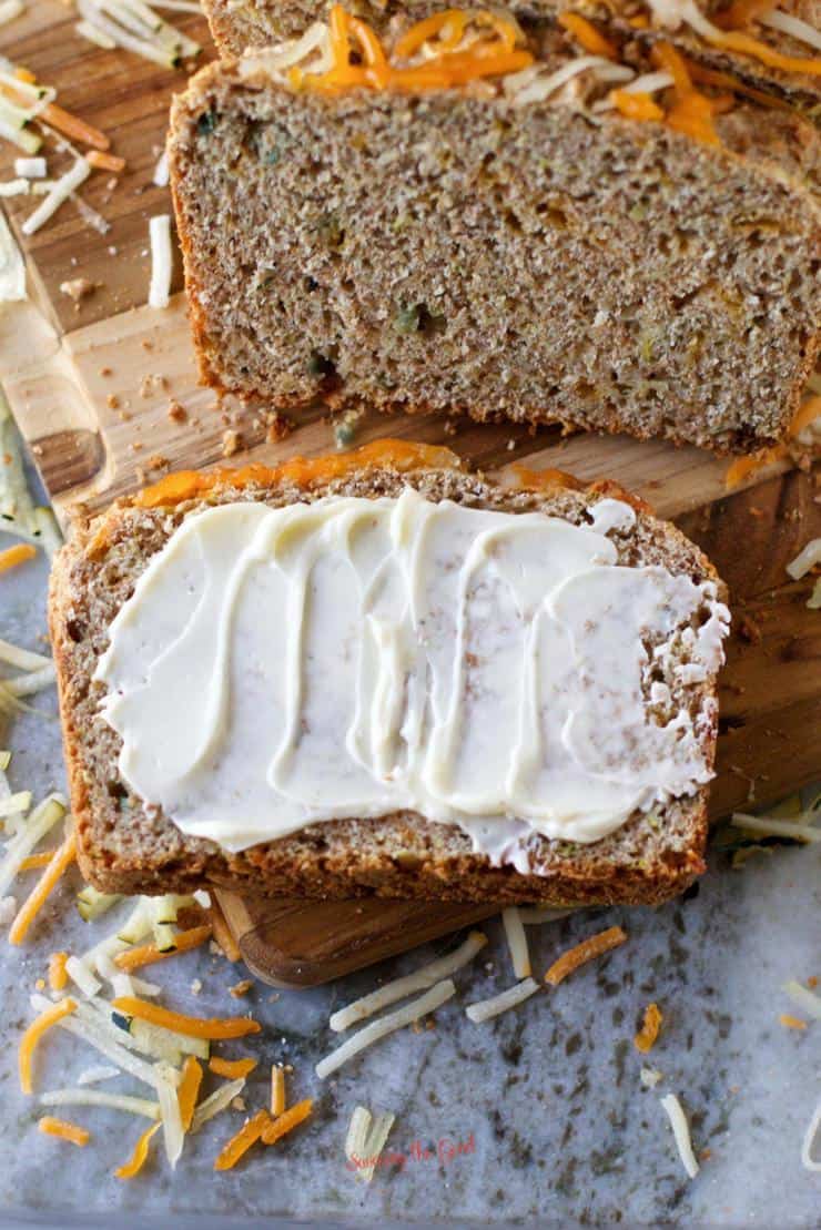 sliced Savory Zucchini Bread with butter spread on cut piece
