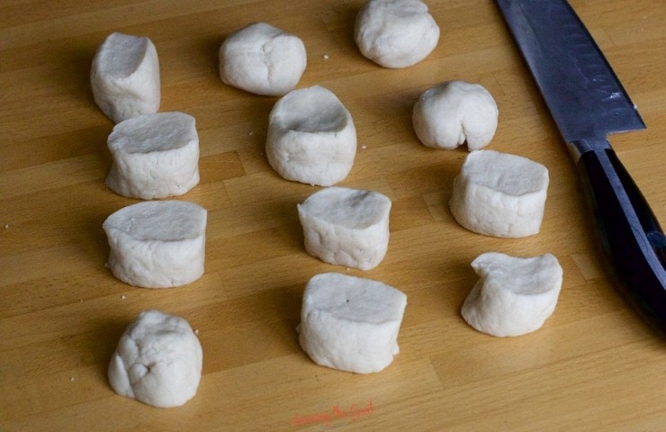 Baleadas dough balls on a wooden counter