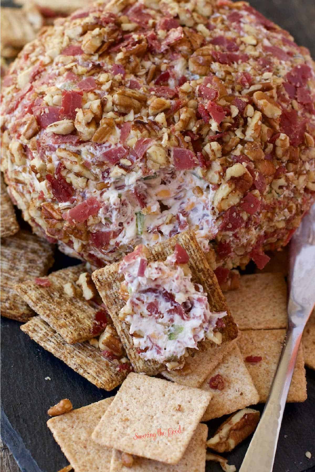 Chipped Beef Cheese Ball with a small portion on a wheat thin
