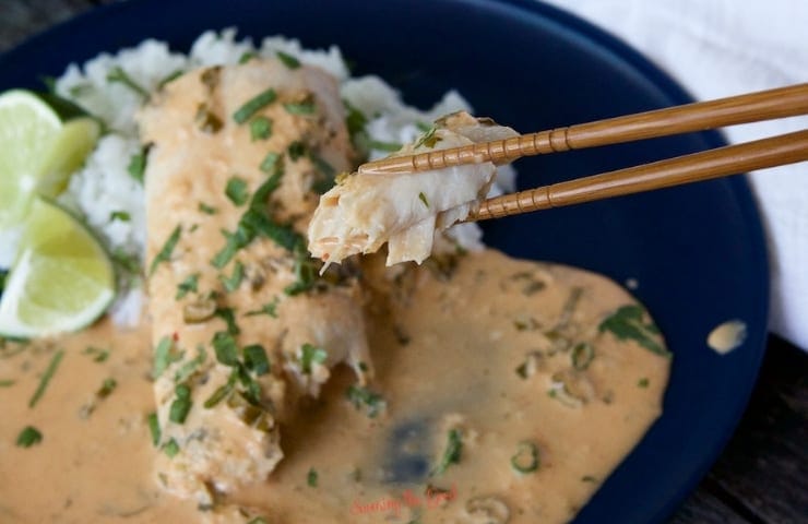 close up of a piece of Mahi-Mahi with Thai Coconut Curry Sauce in chopsticks