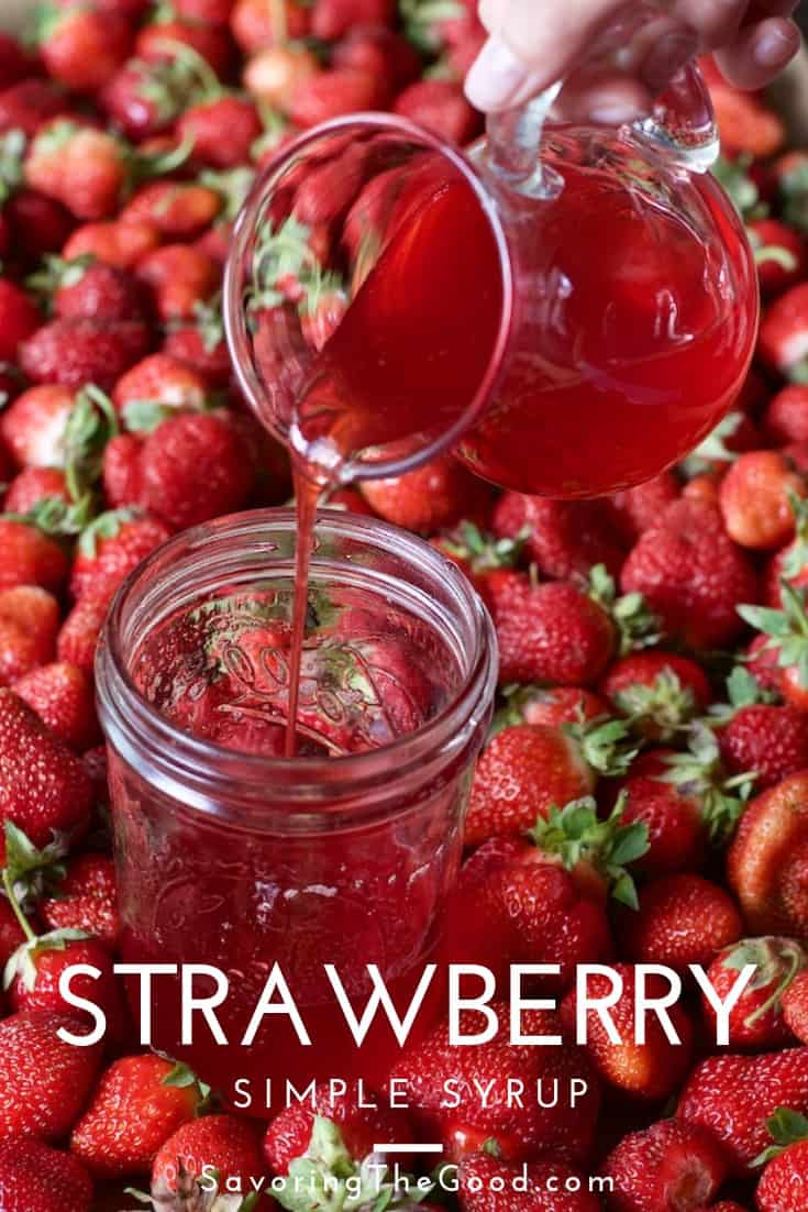 A jar full of strawberries is being infused with strawberry simple syrup.
