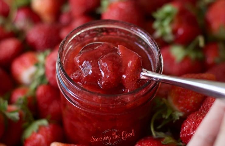 horizontal image of strawberry topping with strawberries in the background