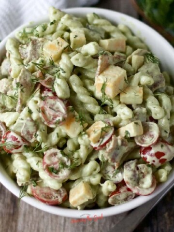 Dill pickle pasta salad in a white bowl.