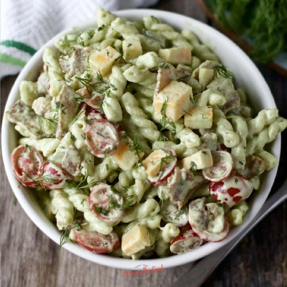 Dill pickle pasta salad in a white bowl.
