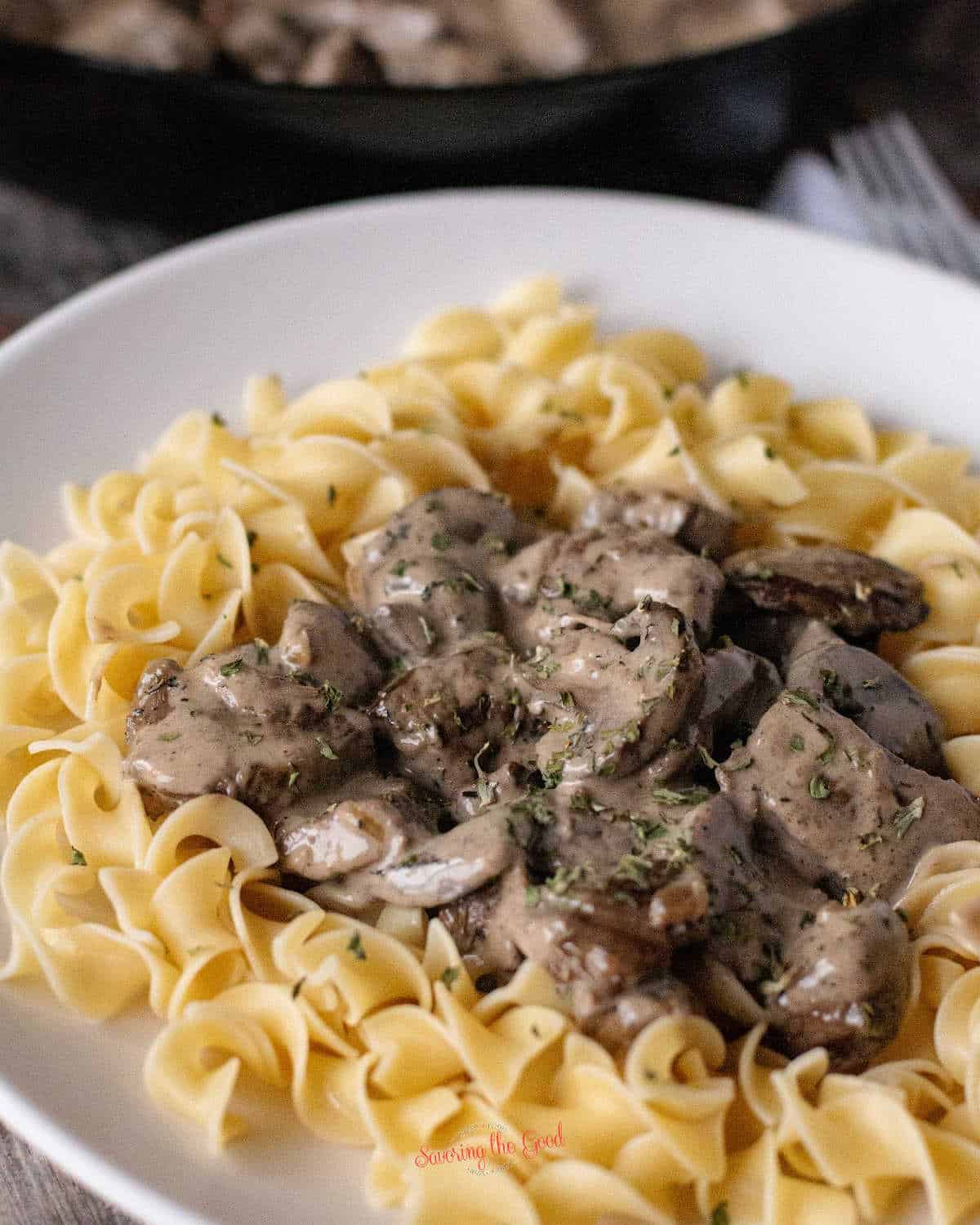 Beef Stroganoff on a plate with more in the background