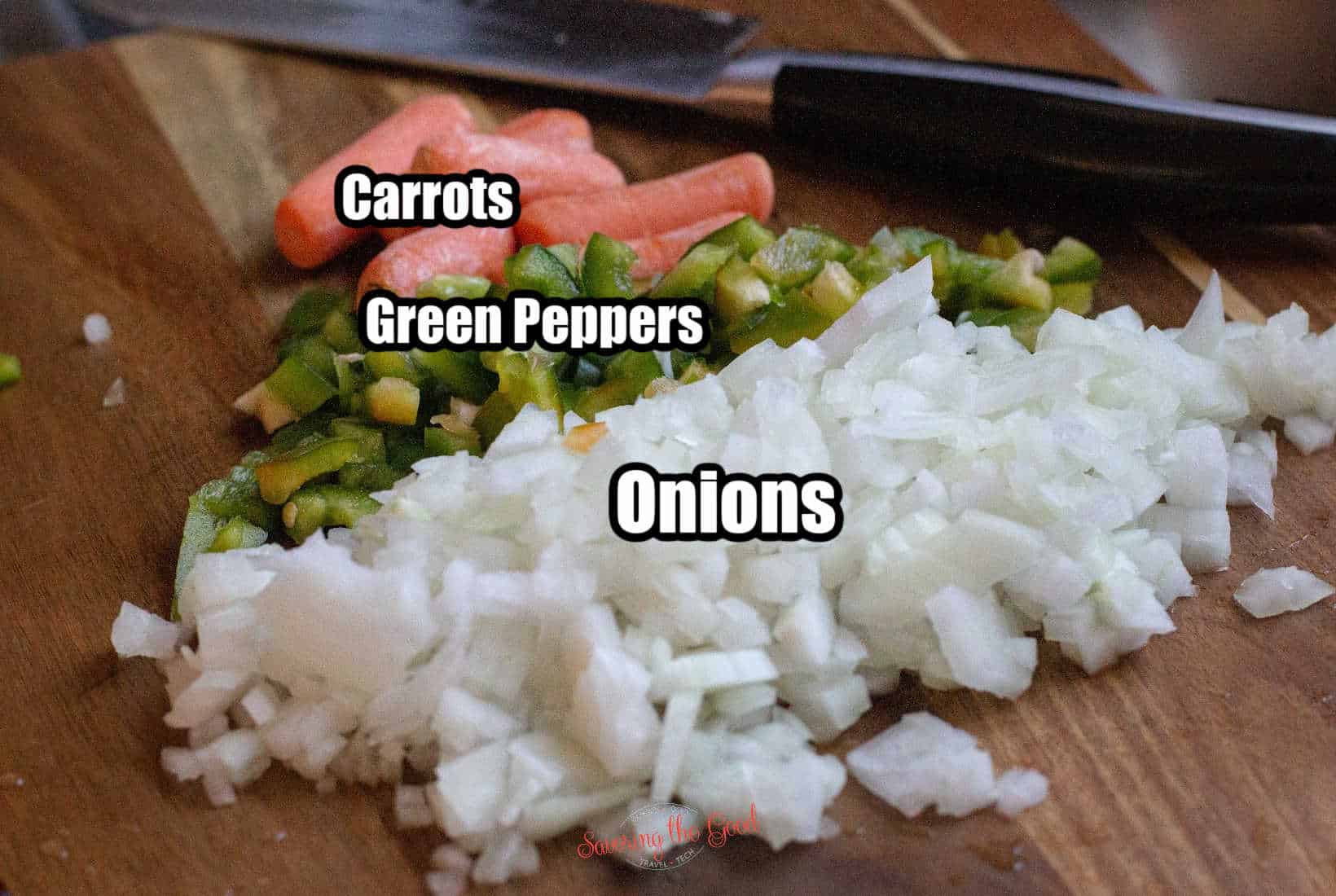 chopped onions pepper and carrot on a cutting board with text overlay labeling the ingredients