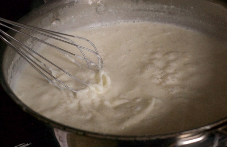 whisking cream sauce for cheesy chicken casserole