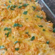 Dorito Chicken Casserole in a black bowl next to a pan of Dorito Chicken Casserole