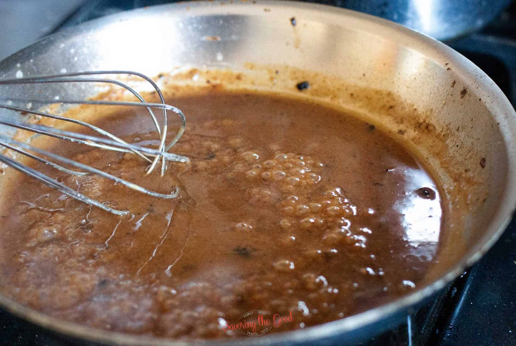 brown turkey gravy bubbling in a pan
