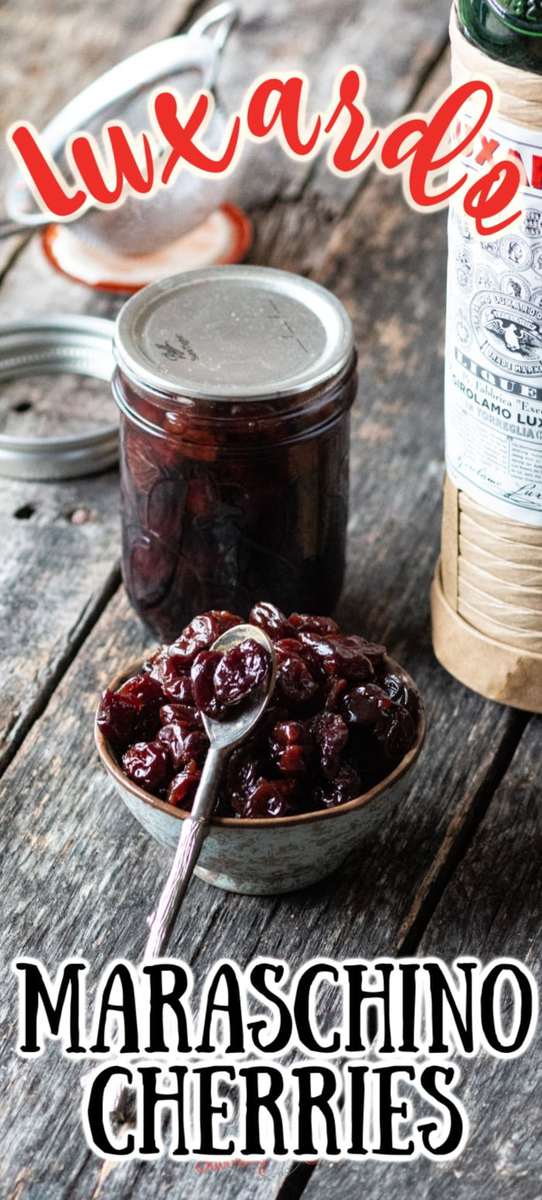Luxardo cherries in jars on a wooden table.