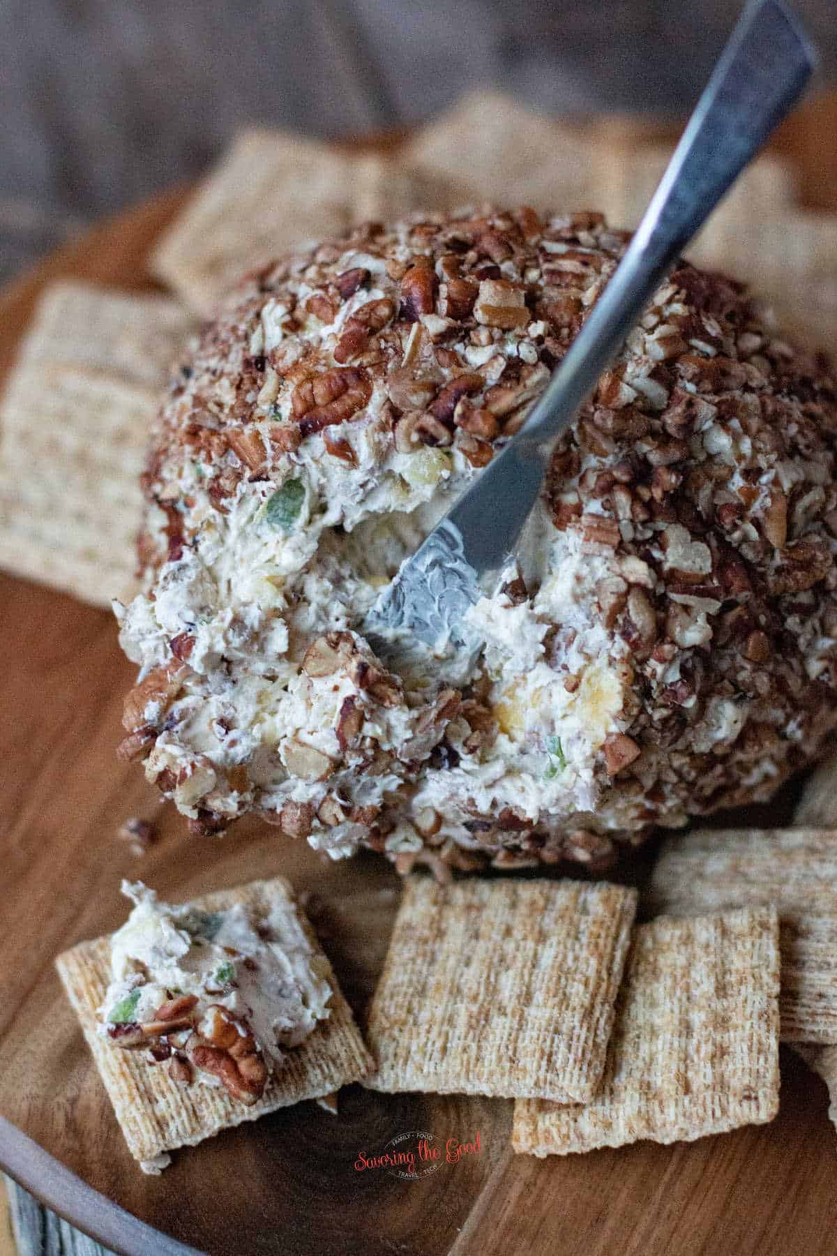 pineapple cheeseball with pecans on the outside, triscuits on the side