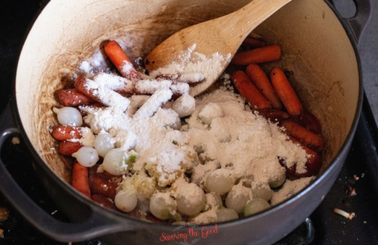 Guinness Beef Stew ingredients in a dutch oven with flour for thickening