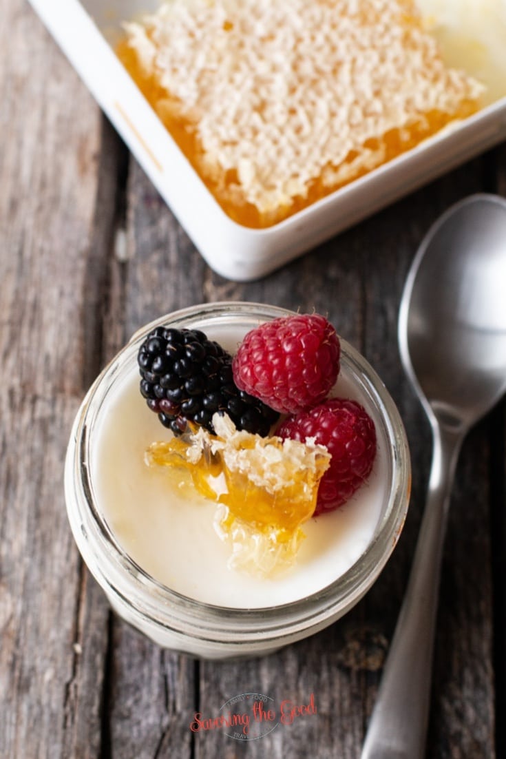 Sous Vide Yogurt in a 4 ounce jar with fruit and honey garnish