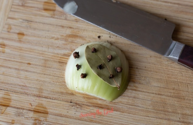 ½ an onion studded with cloves and a bay leaf
