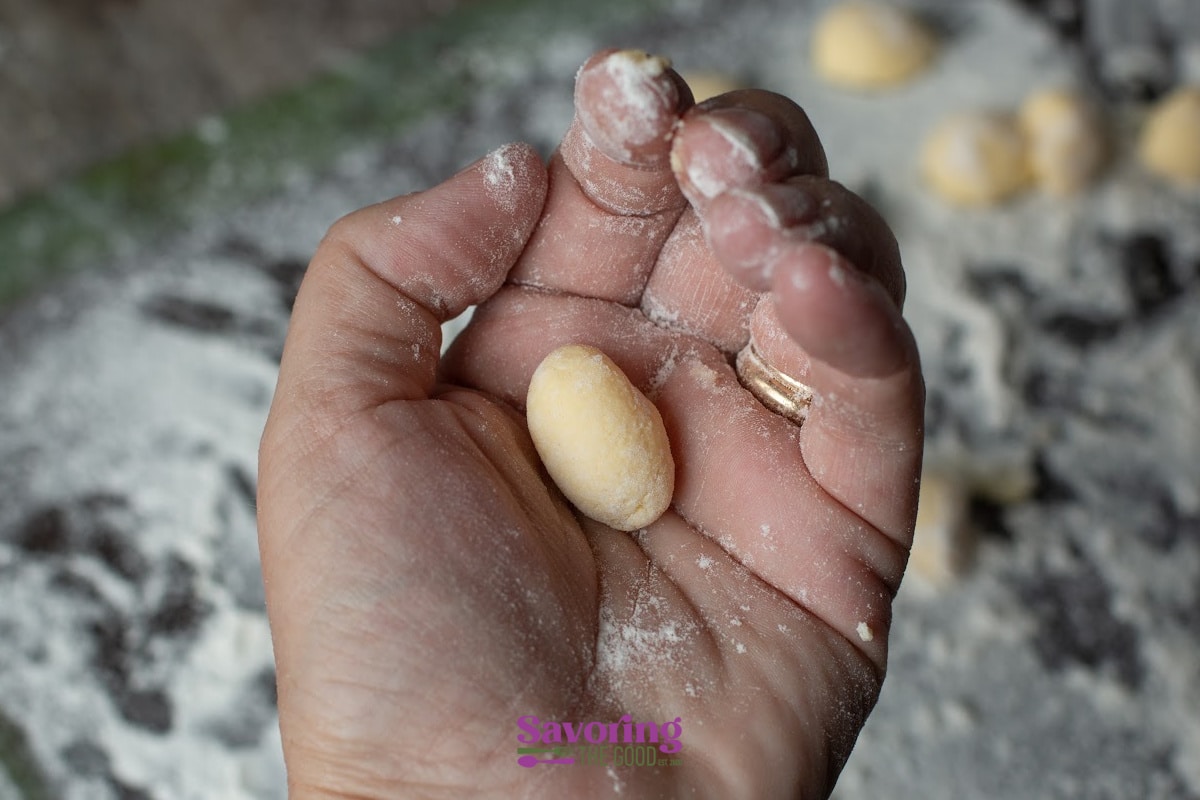 hand rollling gnudi in a floured hand