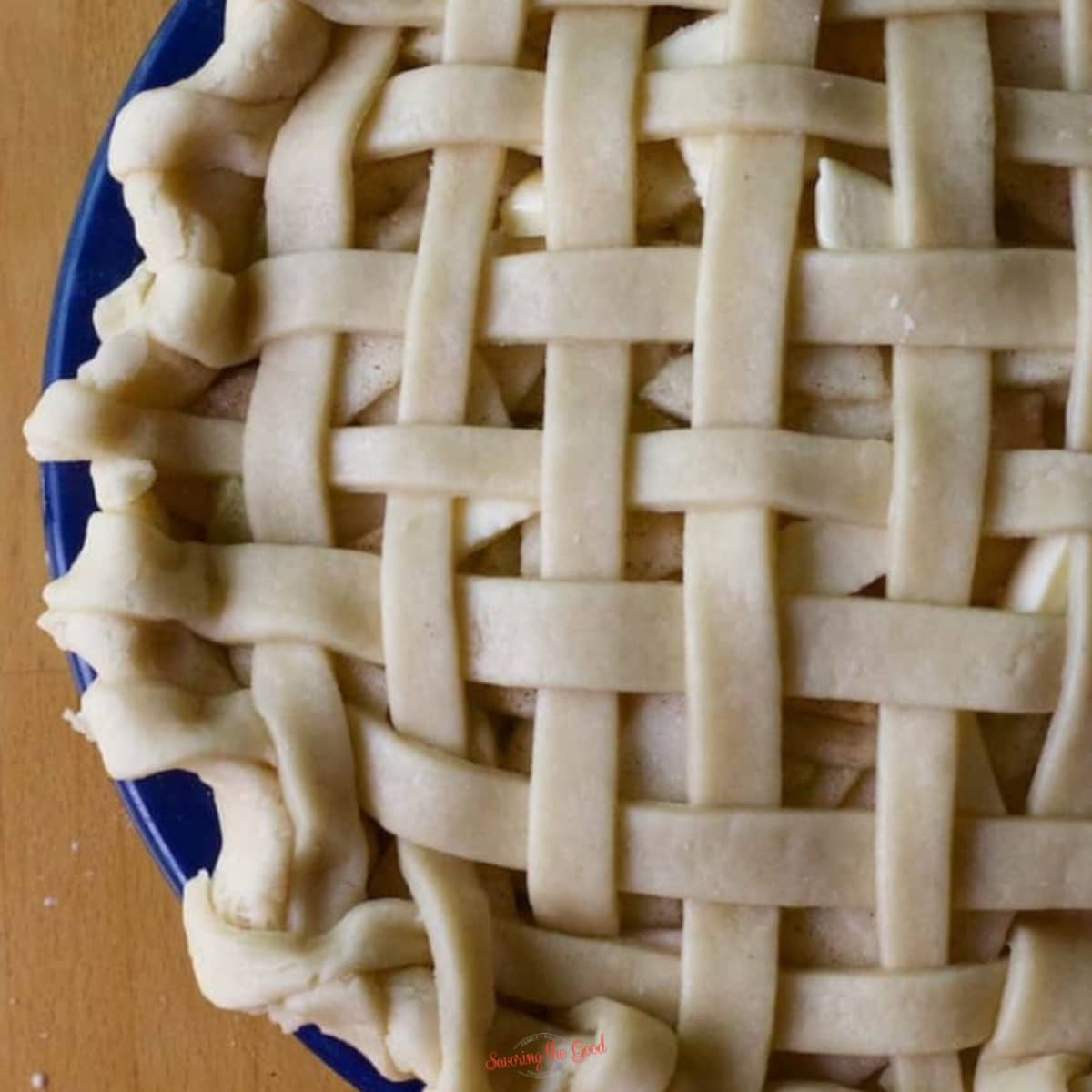 Easy Crisco Pie Crust Recipe used to make a lattice top pie in a blue pie plate.