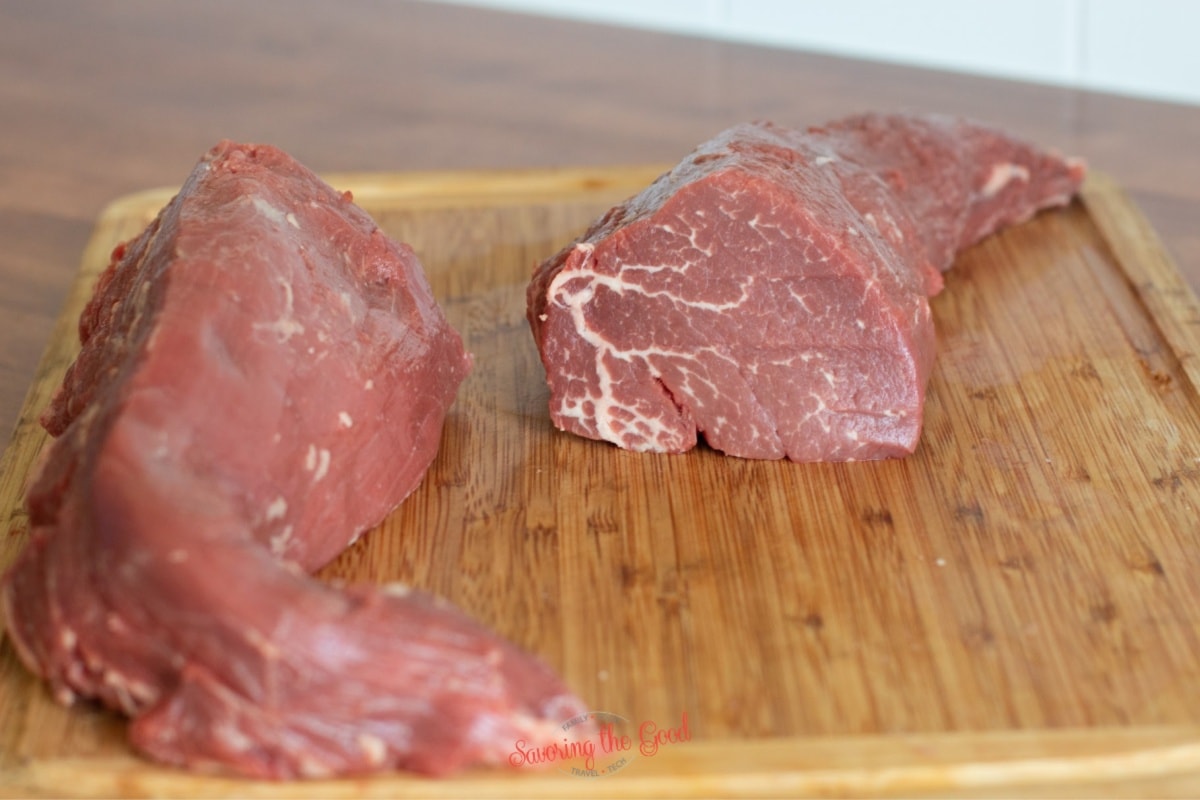 beef tenderloin, raw on a cutting board