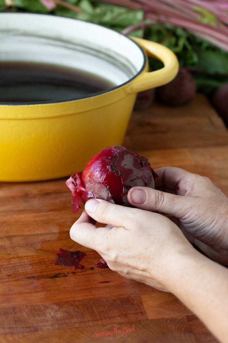 peeling the skin off of a cooked red beet