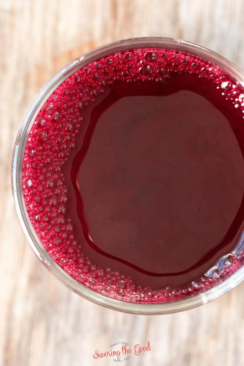 top down image of juiced beet root in a clear glass