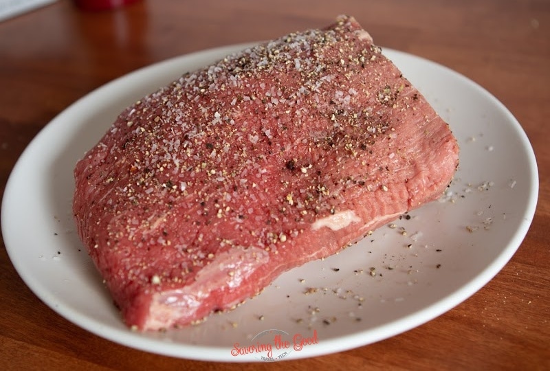 coating all edges of a chruck roast with salt and pepper