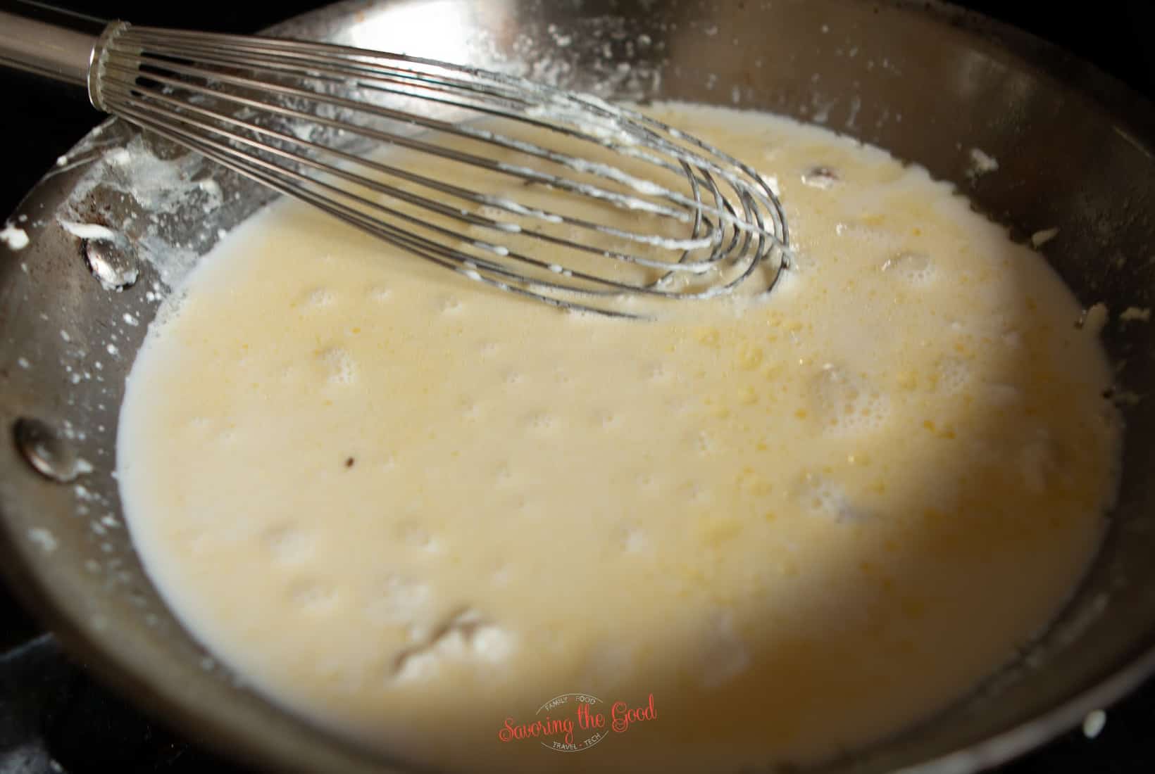 whisking cream cheese, butter and cream to make keto alfredo sauce