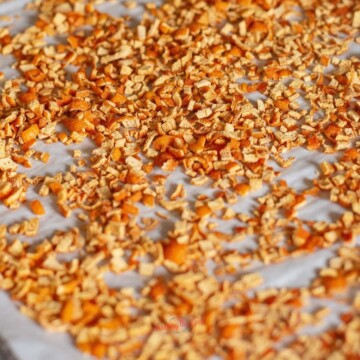 dried orange peel on a parchment lines sheet tray